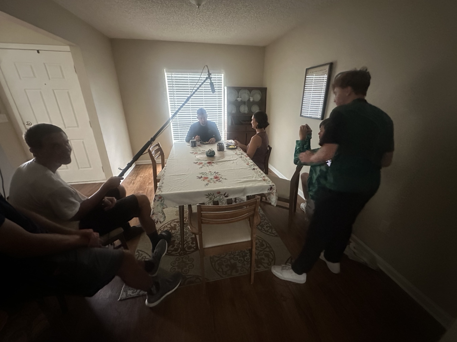 The cast and crew working on a dining-table scene for Freedom St.